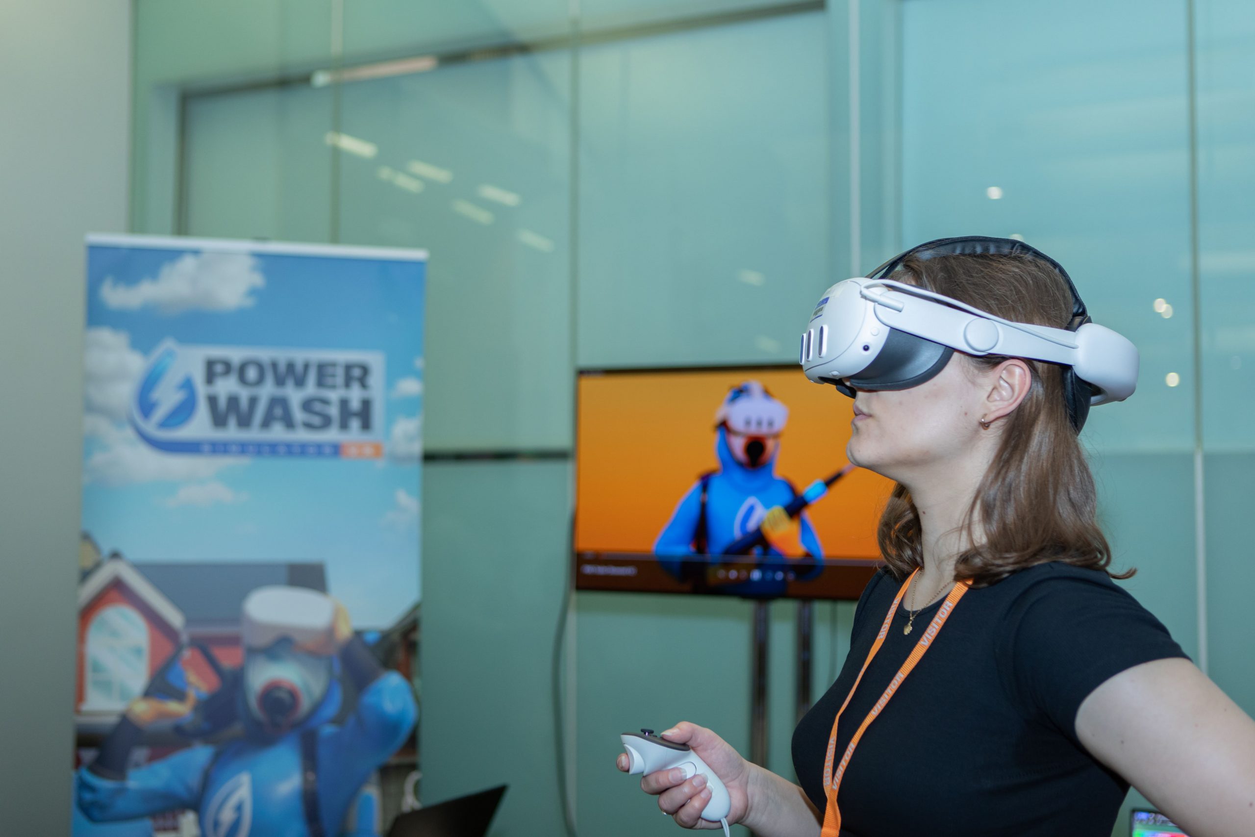 A woman wearing a VR headset playing a video game with a green coloured modern background