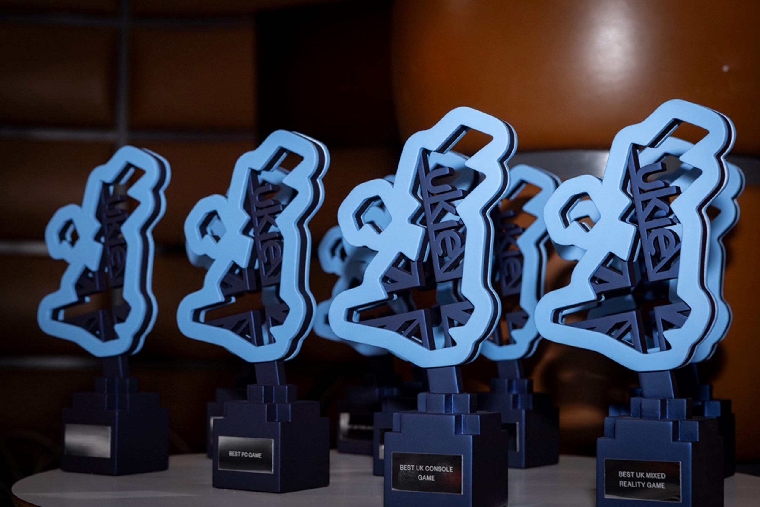 Four video game award trophies